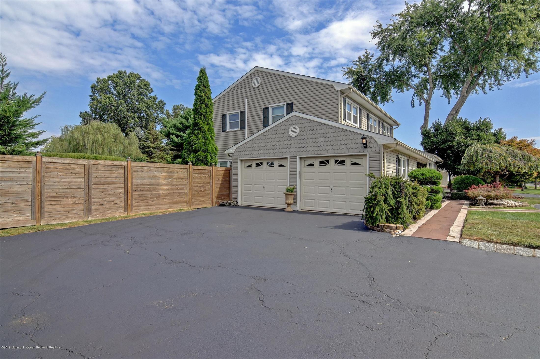 244 Elton Adelphia Road Freehold, NJ 07728 - Photo 28 of 46 a front view of a house with a yard and garage