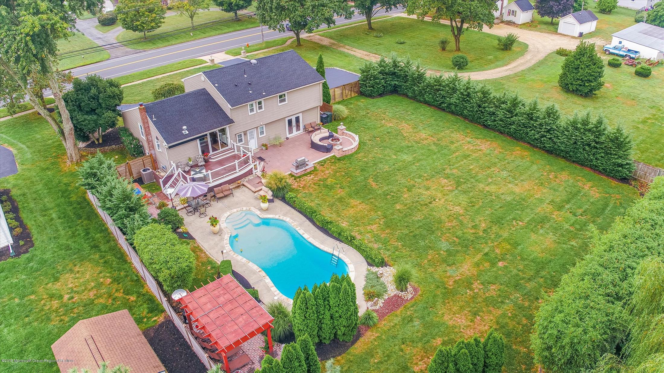 244 Elton Adelphia Road Freehold, NJ 07728 - Photo 46 of 46 an aerial view of a house with a garden and swimming pool