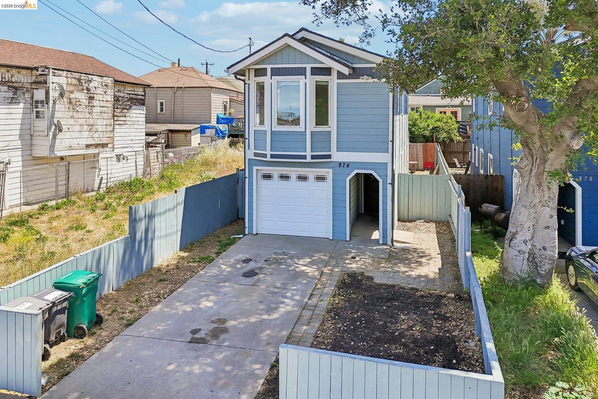 874 Pine Street Oakland, CA 94607 - Photo 29 of 39 Two-story residential structure featuring light blue siding with white trim accents