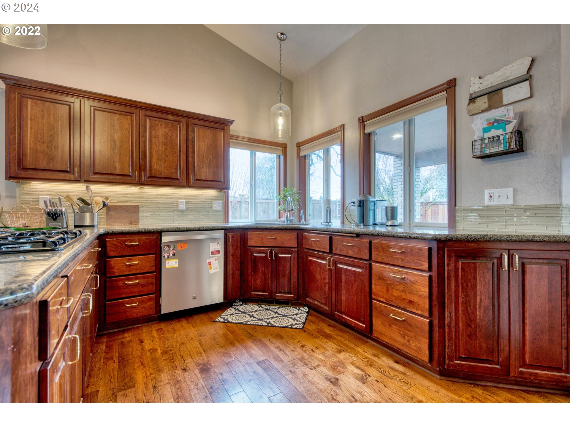 1425 Gilham Road Eugene, OR 97401 - Photo 11 of 30 a kitchen with stainless steel appliances granite countertop wooden cabinets a stove and a sink
