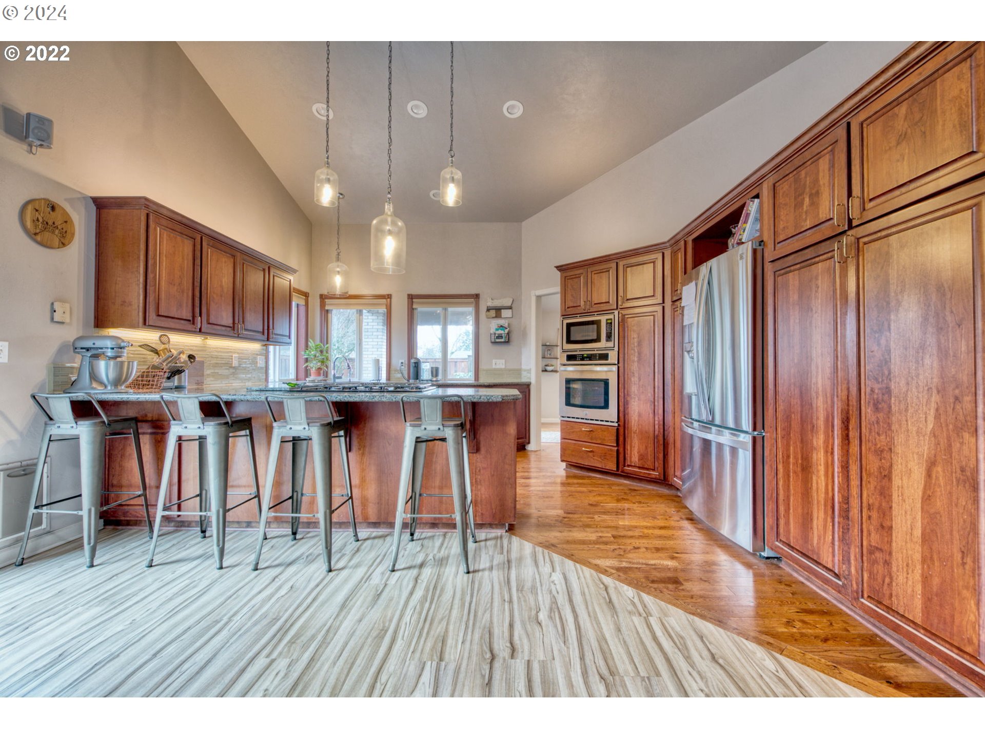 1425 Gilham Road Eugene, OR 97401 - Photo 13 of 30 a open kitchen with stainless steel appliances granite countertop a refrigerator stove top oven and cabinets with wooden floor