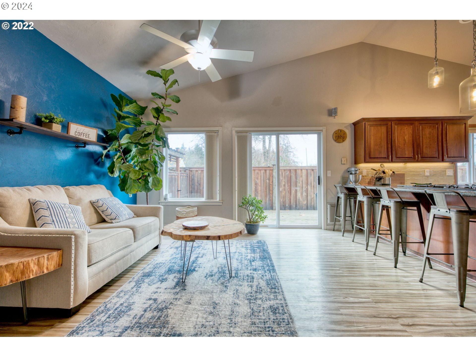 1425 Gilham Road Eugene, OR 97401 - Photo 15 of 30 a living room with furniture and a dining table with wooden floor