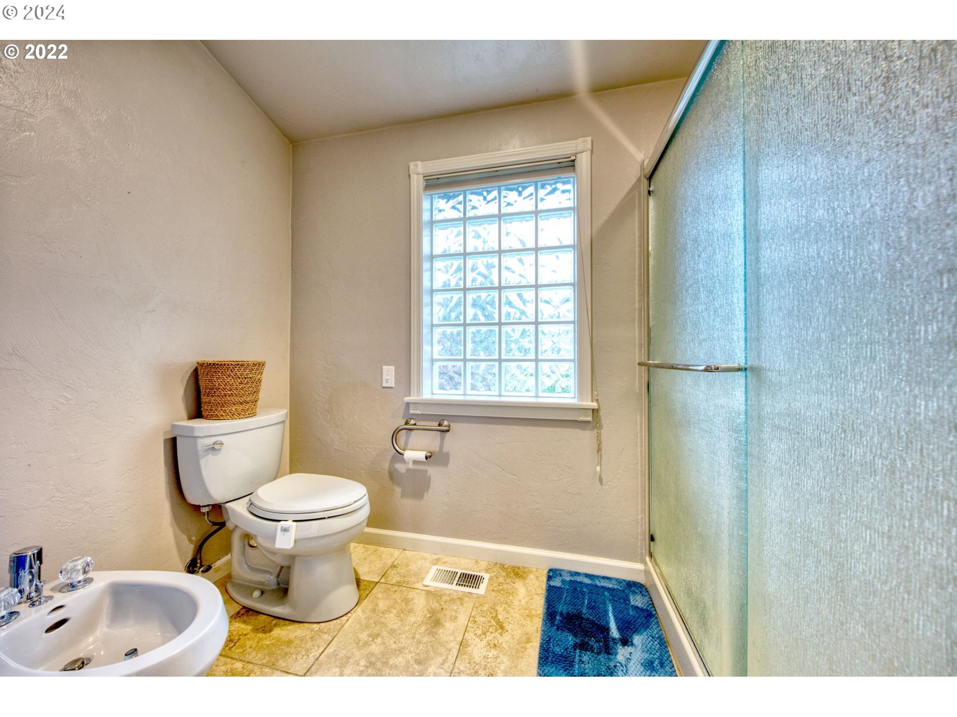 1425 Gilham Road Eugene, OR 97401 - Photo 22 of 30 a bathroom with a granite countertop toilet a sink and a window
