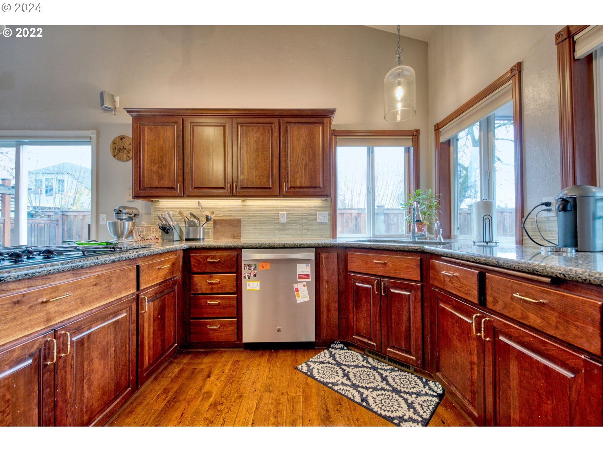 1425 Gilham Road Eugene, OR 97401 - Photo 9 of 30 a kitchen with stainless steel appliances granite countertop wooden cabinets a sink and dishwasher