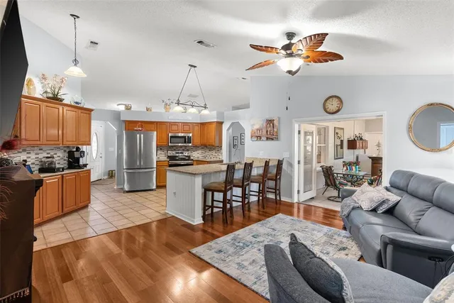 a living room with kitchen island furniture and a chandelier