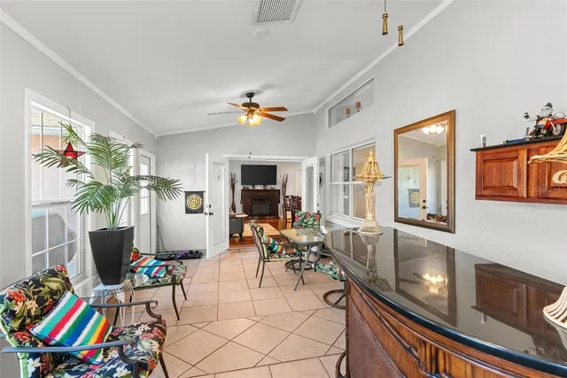 a backyard view of a house with garden and patio