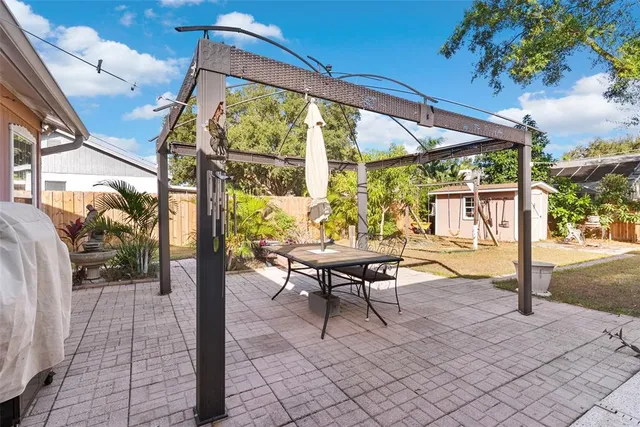 a view of a house with backyard porch and sitting area