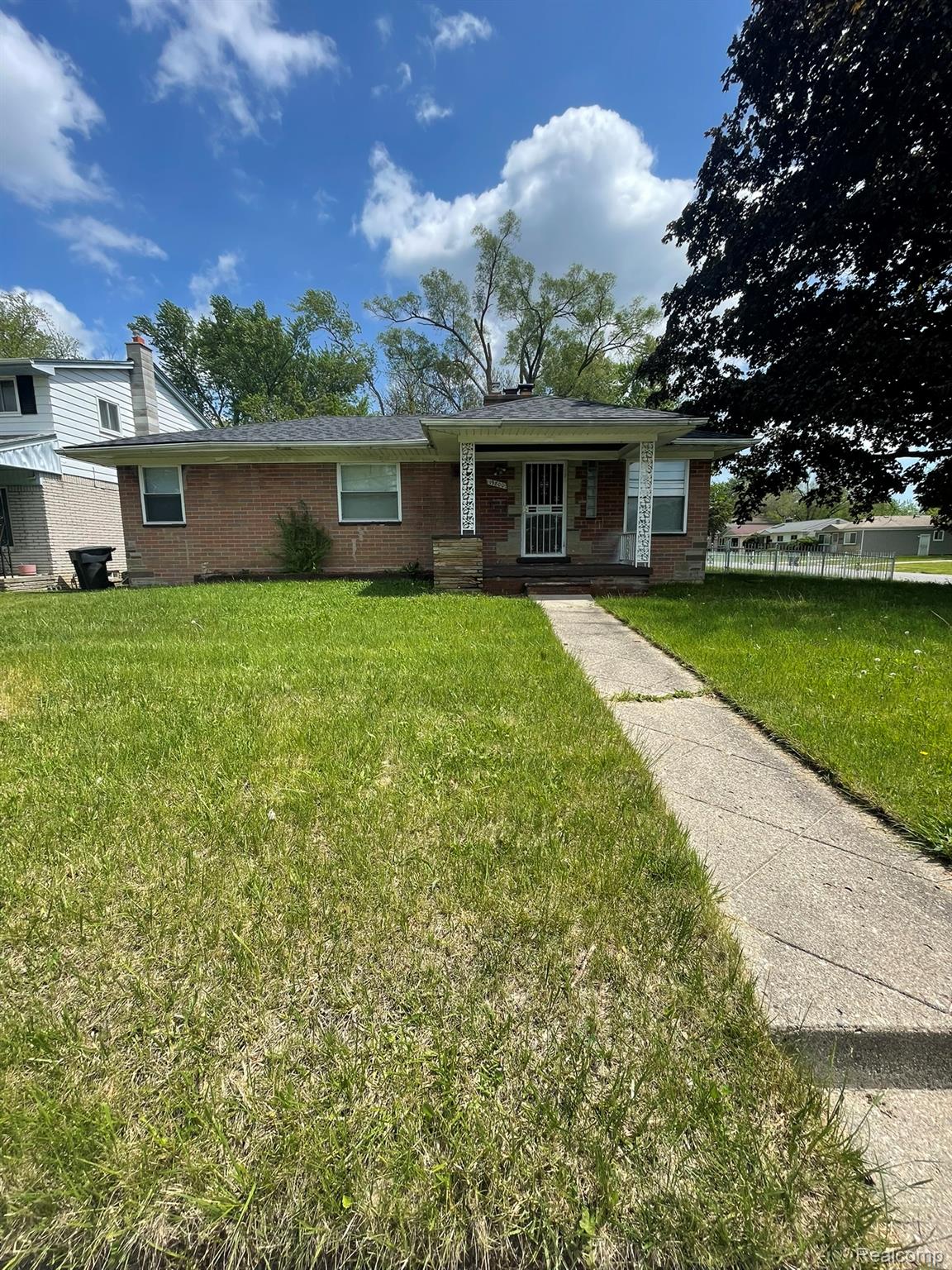 19800 Berg Road Detroit, MI 48219 - Photo 3 of 13 Brick ranch-style residence featuring a covered front porch, a gabled roofline, and a concrete pathway
