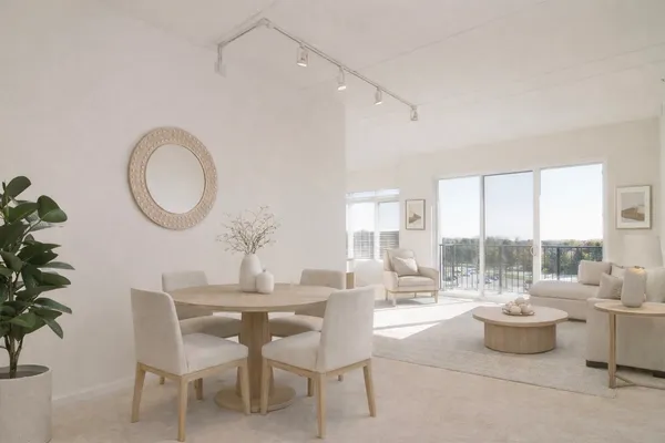 a dining room with furniture and a large window