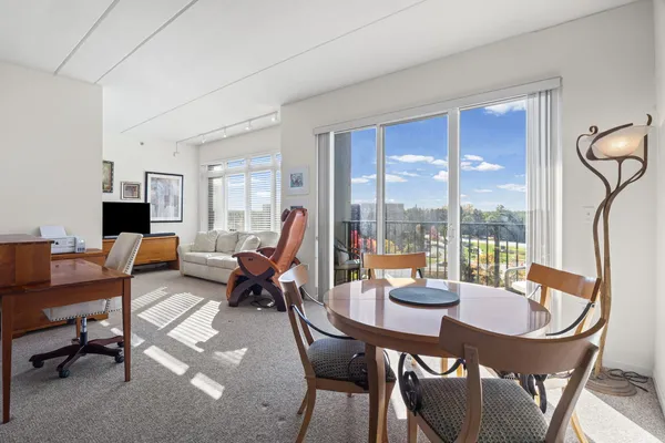 a living room with furniture a table and a large window