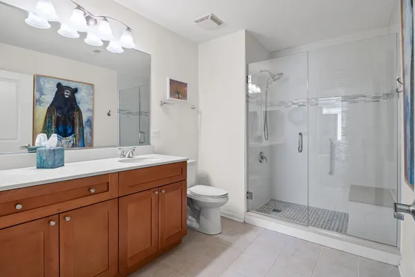 a bathroom with a double vanity sink mirror and shower