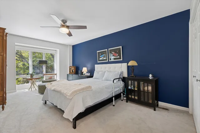 a bedroom with bed and a chandelier