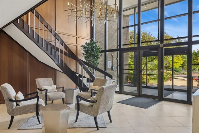 a living room with furniture and a floor to ceiling window