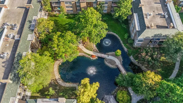 an aerial view of a residential apartment building with a yard and potted plants