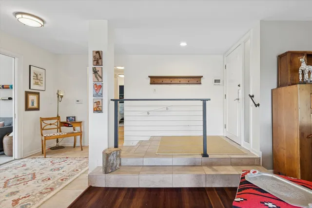a living room with furniture a mirror and a dining table