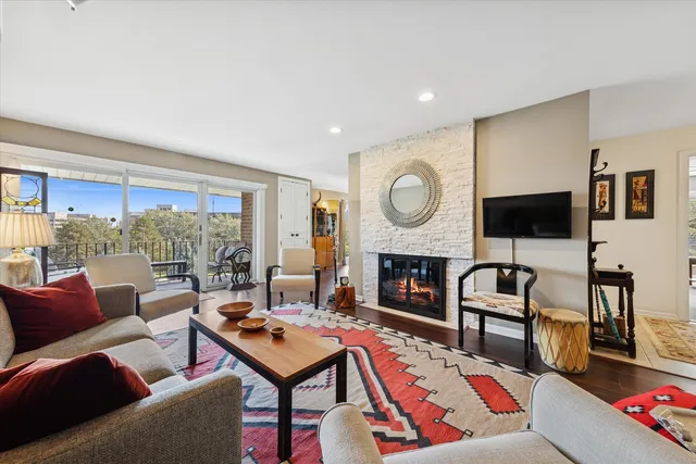 a living room with furniture a fireplace and a table