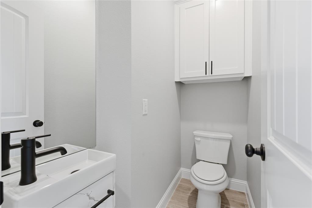 420 Ball Street Tom Bean, TX 75491 - Photo 23 of 34 a bathroom with a sink toilet and a mirror
