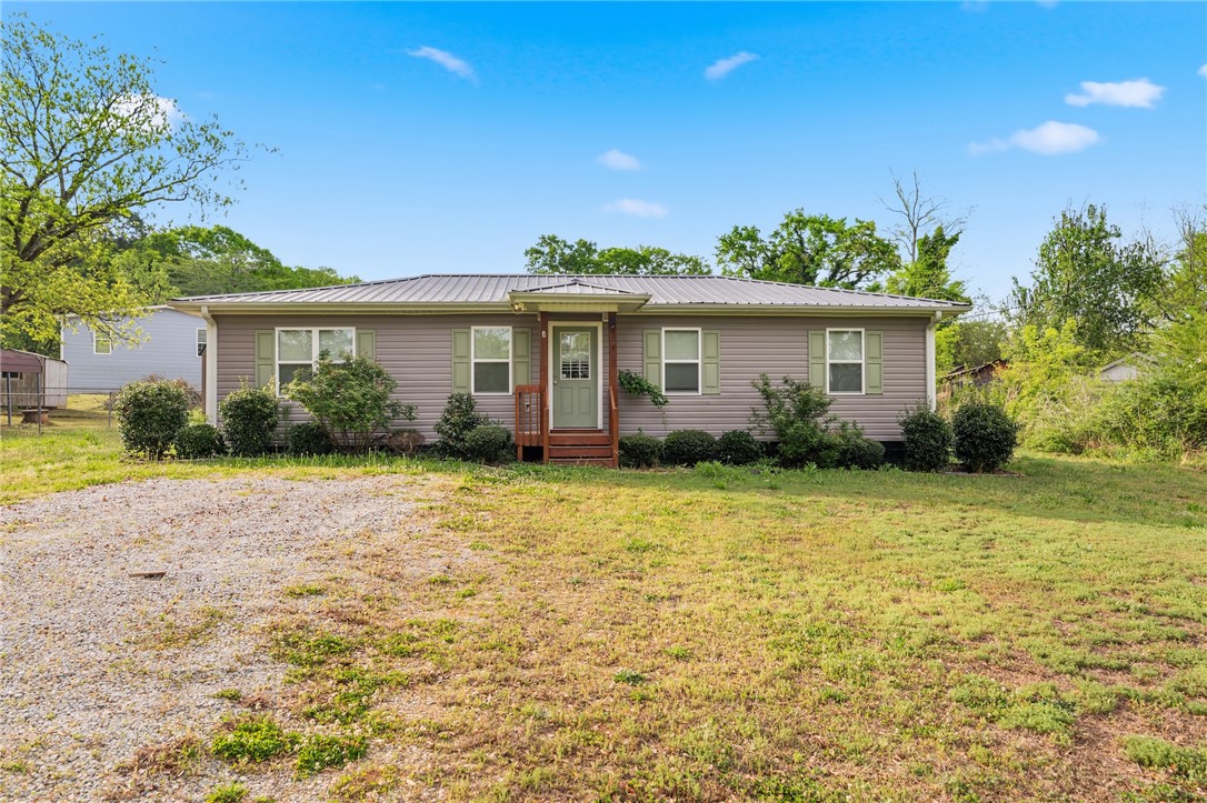 This charming residence features a well-maintained exterior and a welcoming front entrance.