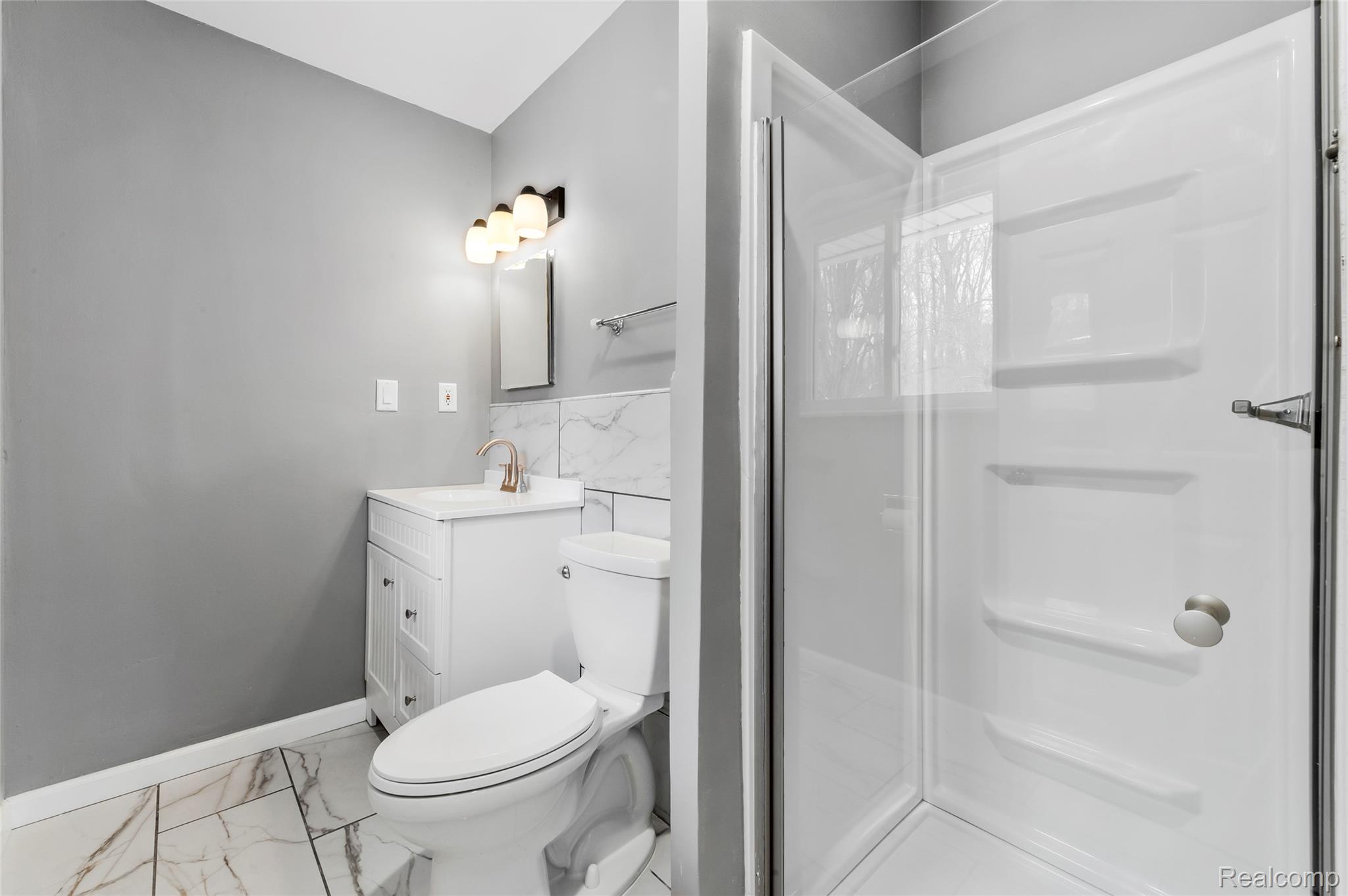 13515 Lenmoore Road Belleville, MI 48111 - Photo 24 of 41 Full bath featuring vanity, light marble finish floors, and a stall shower