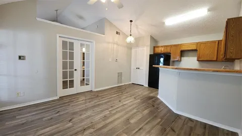 a view of a kitchen with wooden floor and a sink