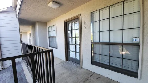 a view of staircase with railing and a window
