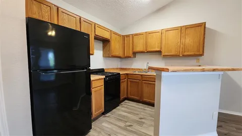 a kitchen with a refrigerator and a stove