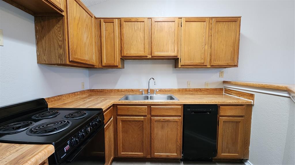 6108 Abrams Road, Unit 627 Dallas, TX 75231 - Photo 5 of 13 a kitchen with stainless steel appliances granite countertop a sink stove and cabinets
