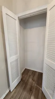 a view of hallway with wooden floor