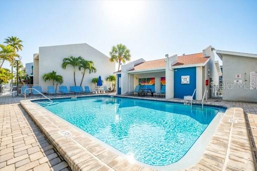 337 Rex Place, Unit A Madeira Beach, FL 33708 - Photo 27 of 48 swimming pool view with a seating space and a garden view