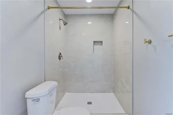 a bathroom with a shower and toilet