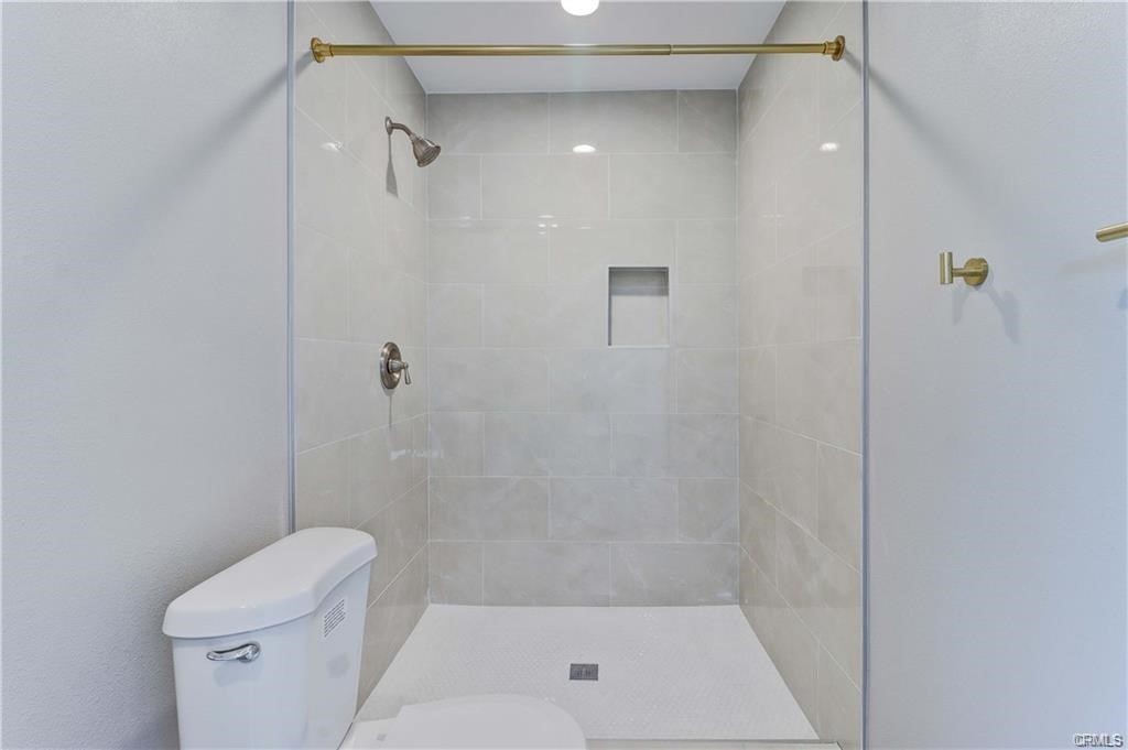 409 Olive Street, Unit B Placentia, CA 92870 - Photo 6 of 11 a bathroom with a shower and toilet