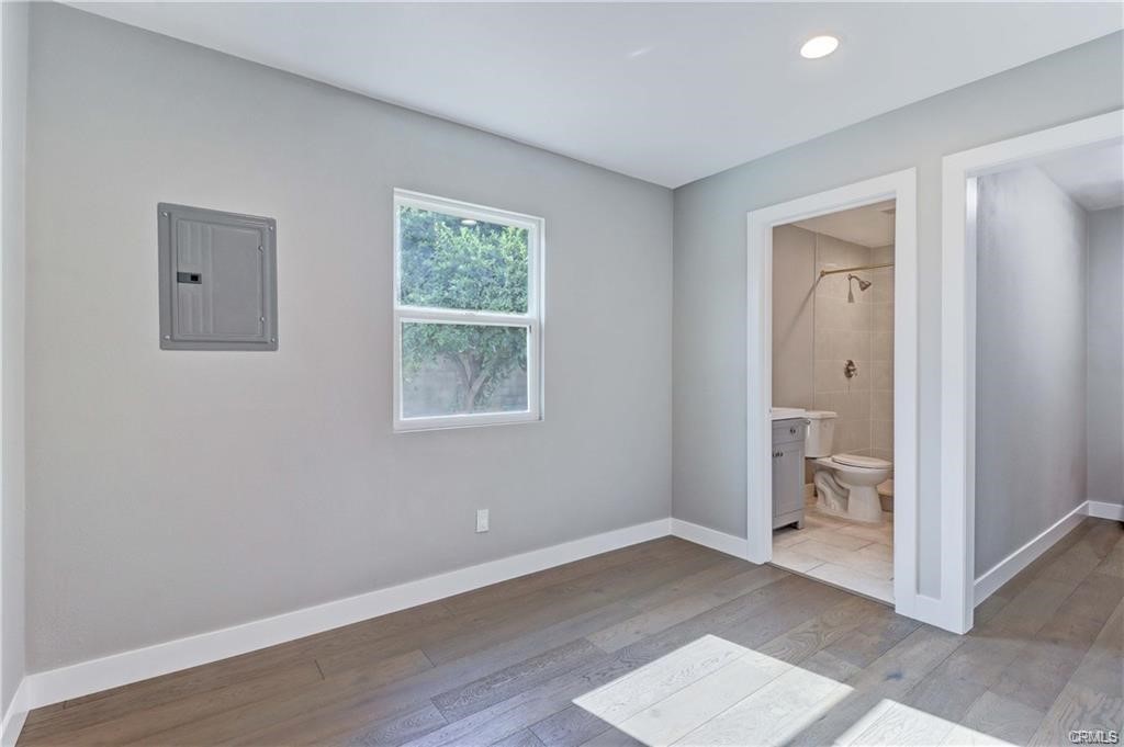 409 Olive Street, Unit B Placentia, CA 92870 - Photo 9 of 11 an empty room with wooden floor and a window