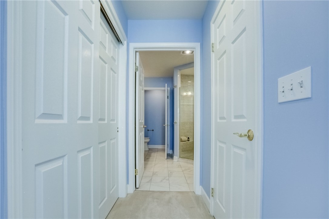 3243 Abbey Road Buffalo, NY 14224 - Photo 20 of 36 The hallway to the main suite bathroom is flanked