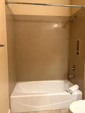 a bathroom with a shower and a toilet