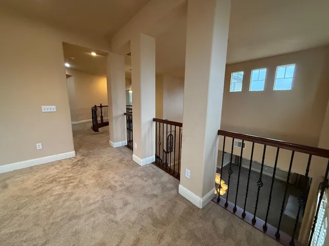 a view of a hallway with a livingroom and a fireplace