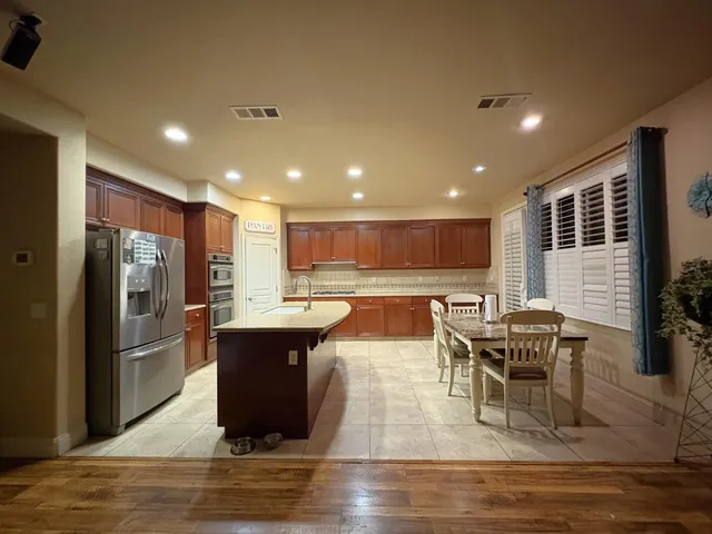 a view of a dining room with furniture a rug and wooden floor