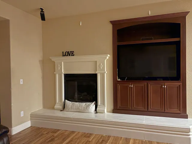a living room with a fireplace and a flat screen tv
