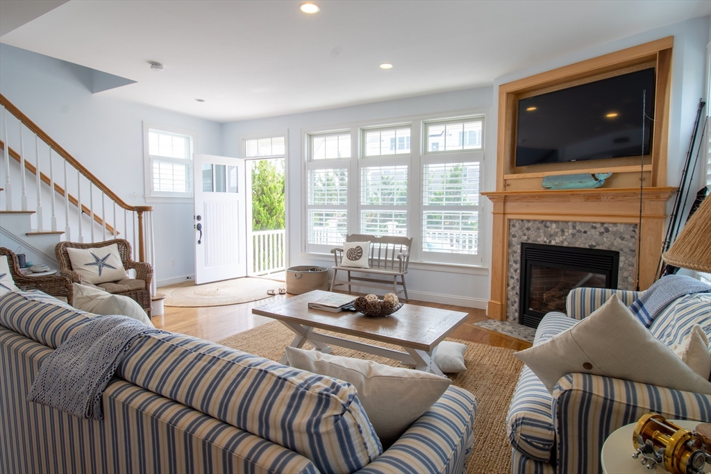 117 River Street Scituate, MA 02050 - Photo 2 of 23 a living room with furniture a flat screen tv and a fireplace
