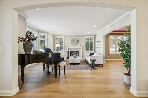 a living room with furniture fireplace and a large window
