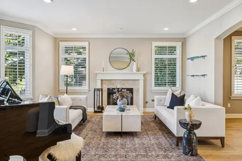 a living room with furniture and a piano