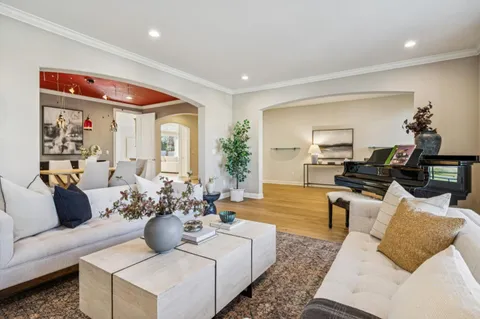 a dining room with furniture a fireplace and wooden floor