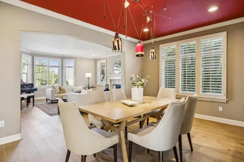 a room with lots of wooden furniture and large windows