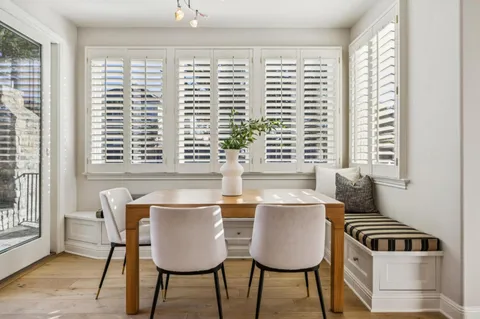 a view of a hallway with wooden floor and entryway