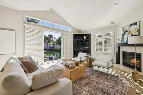 a living room with furniture and large windows