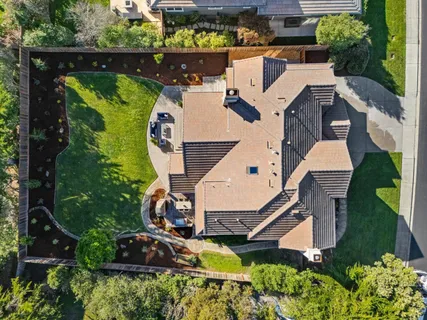 a front view of a house with potted plants