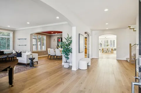 a living room with fireplace furniture and a large window