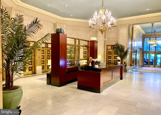 a living room with fireplace furniture and a chandelier