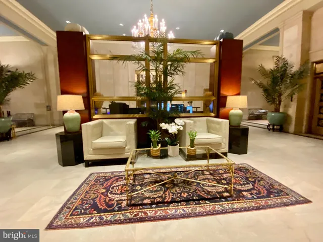 a living room with furniture chandelier and a chandelier