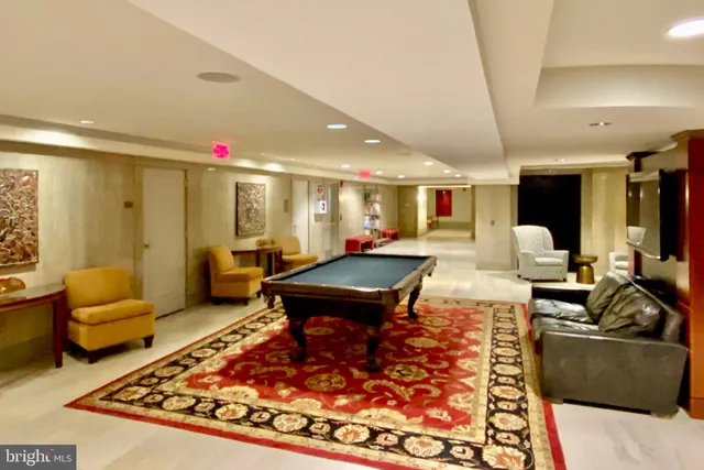 a living room with furniture a rug and a flat screen tv
