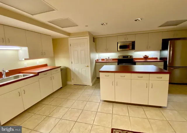 a kitchen with stainless steel appliances a sink cabinets and a counter top space